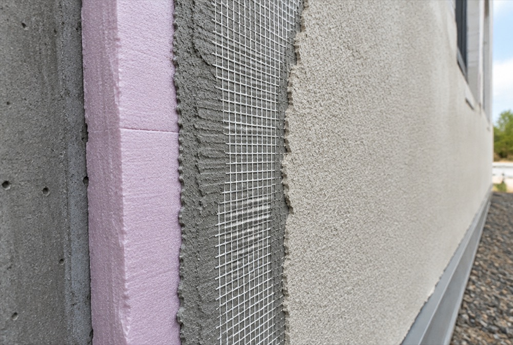 Synthetic stucco EIFS wall system with foam board and reinforcing mesh